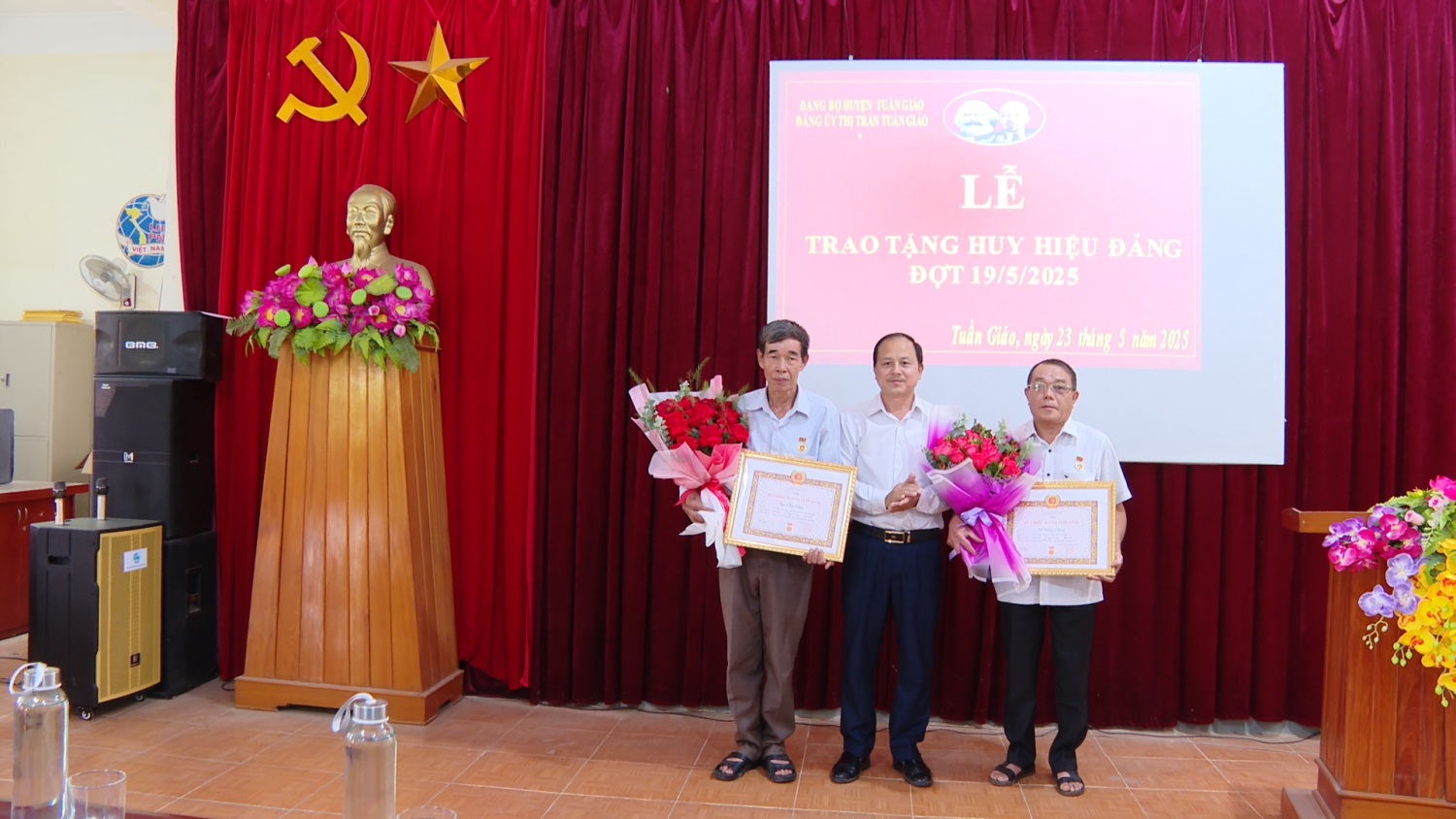 Đồng chí Giàng A Dơ UVBTV Huyện uỷ, Bí thư Đảng uỷ Thị trấn Tuần Giáo trao huy hiệu 40 năm tuổi đảng cho 02 đảng viên